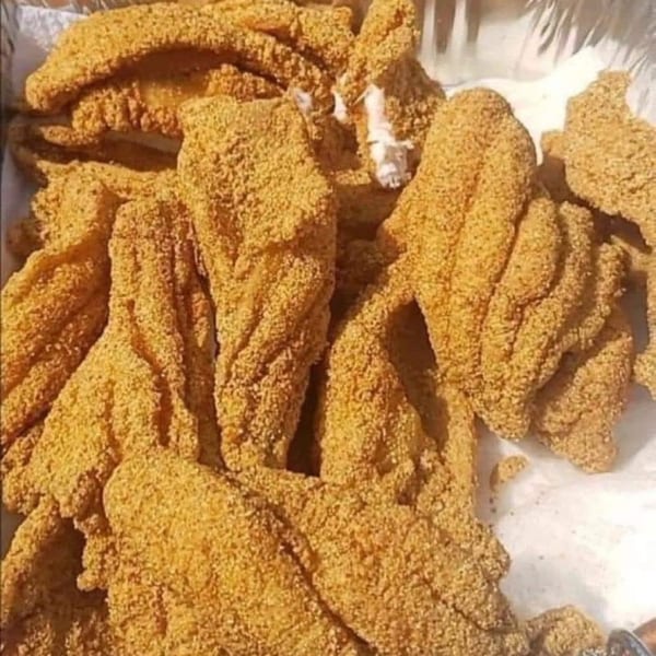 Close-up of golden-brown fried fish fillets, likely catfish, from Shantell's Just Until Restaurant & Lounge.
